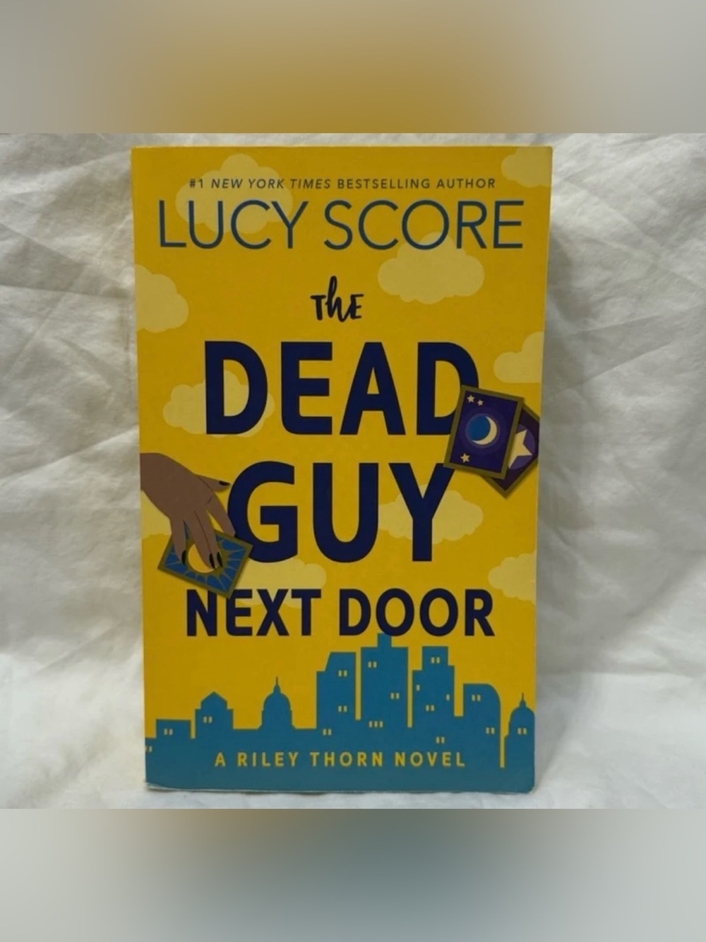 “The Dead Guy Next Door: A Riley Thorn Novel” Paperback Romance by Lucy Score